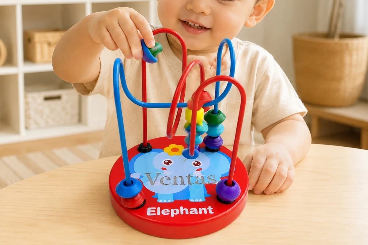 Child playing with VENTAS elephant bead maze